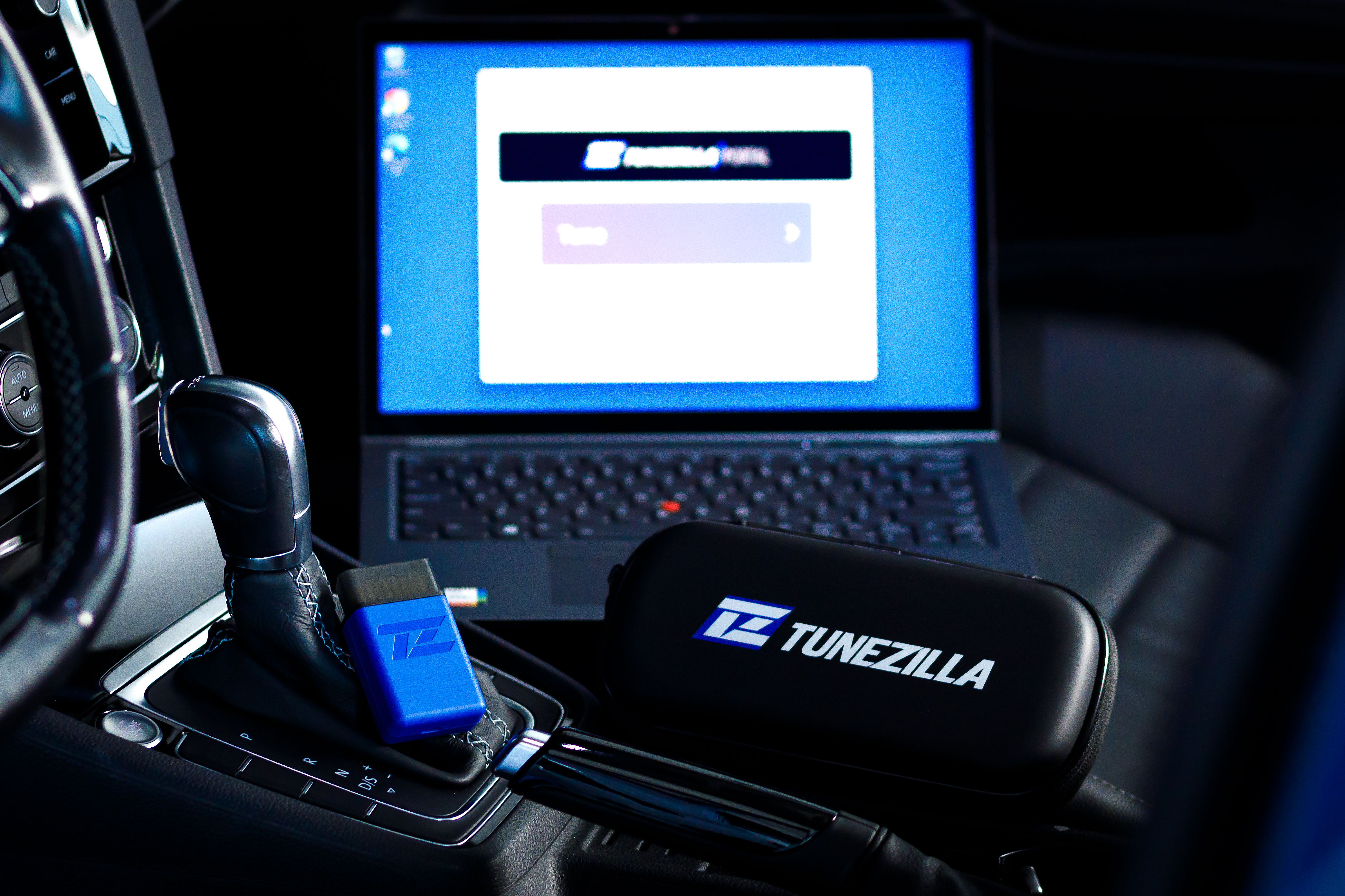 Blue FlashZilla Pro OBD interface and TuneZilla case in a VW cabin
